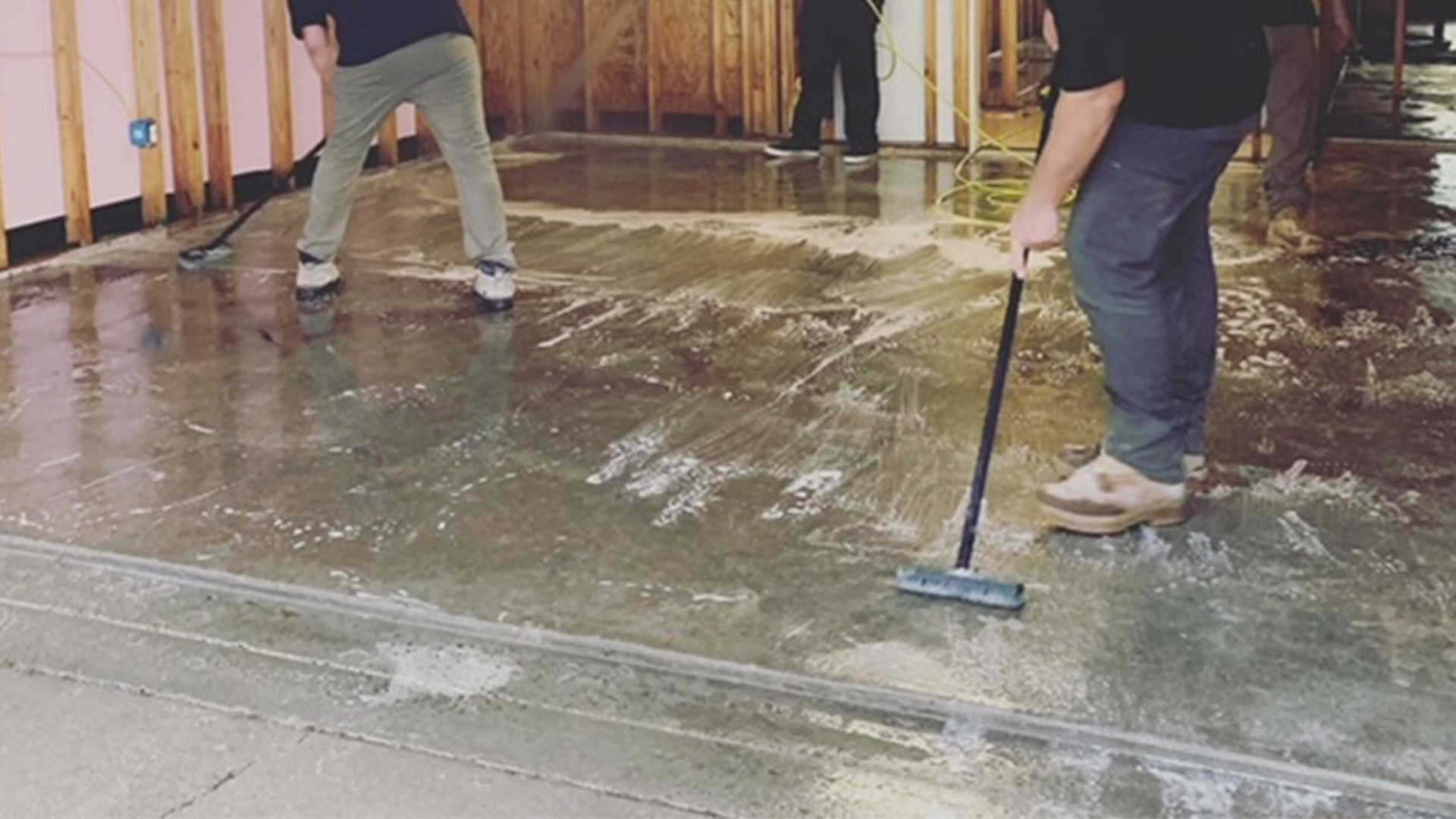 group of contractor cleaning concrete flooring for restoration birmingham al